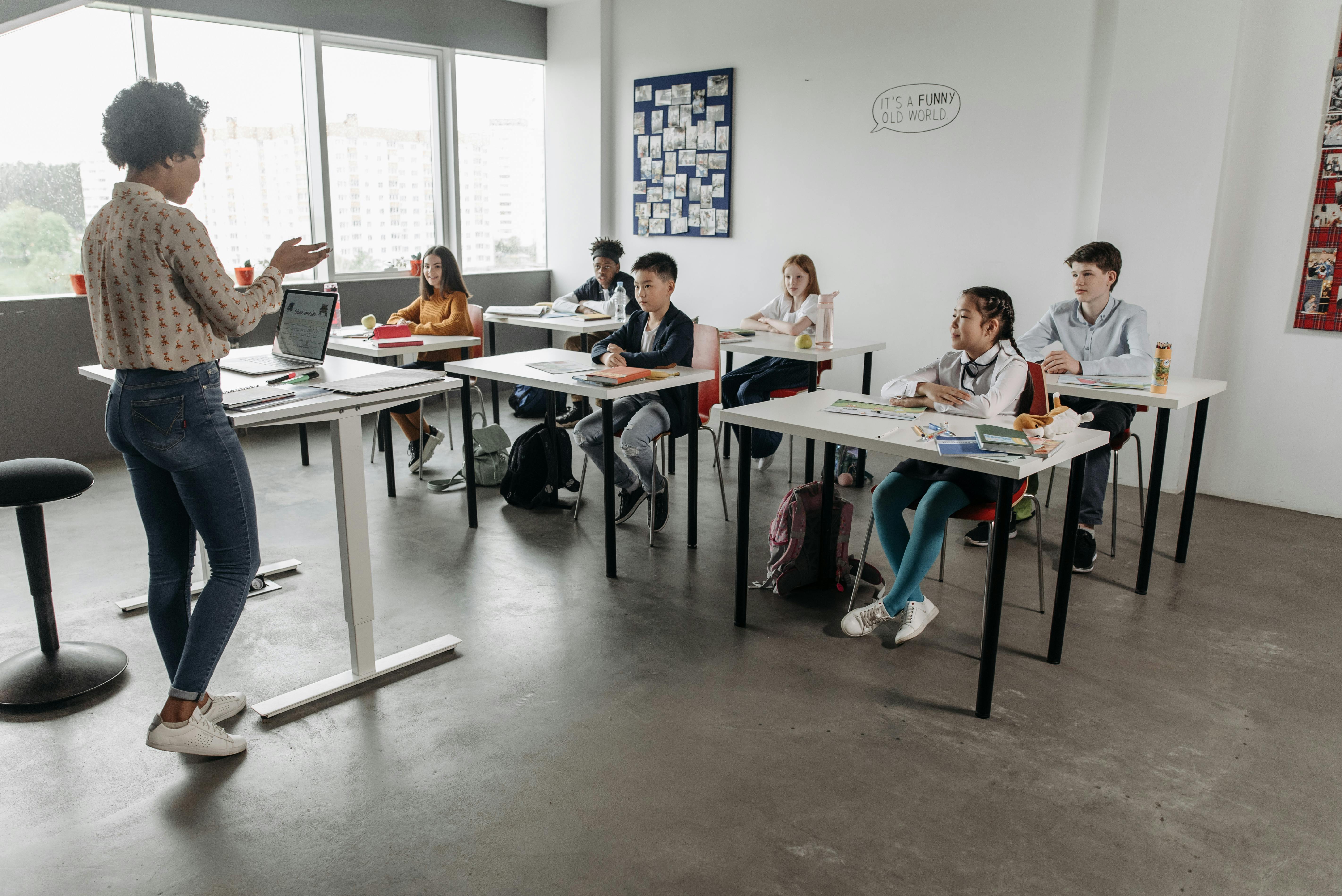 Diverse small classroom with students seated at desks and engaged in learning